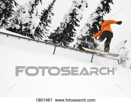 Person snowboarding on a railing View Large Photo Image Stock Image - Person snowboarding on a railing. Fotosearch