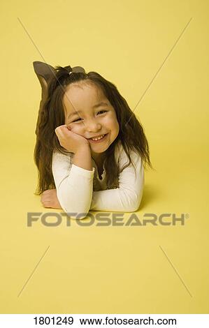 Stock Photo - Portrait of little girl relaxing. Fotosearch