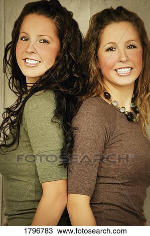 Portrait of twin sisters View Large Photo Image Stock Image - Portrait of twin sisters. Fotosearch