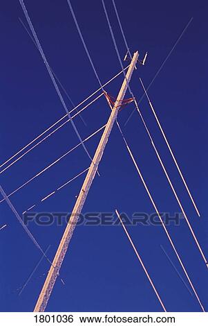 Power lines against blue sky View Large Photo Image Stock Photograph - Power lines against blue sky. Fotosearch