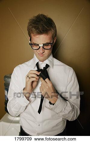 Stock Photo - Putting on a neck tie. Fotosearch