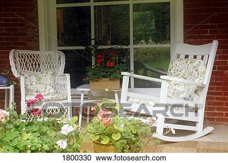 Stock Image - Rocking chairs on country porch . Fotosearch