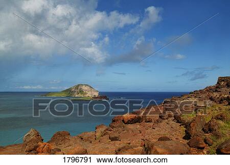 Rocky beach and distant island View Large Photo Image Stock Image - Rocky beach and distant island. Fotosearch