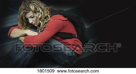 Sad girl sitting alone View Large Photo Image Stock Photo - Sad girl sitting alone. Fotosearch