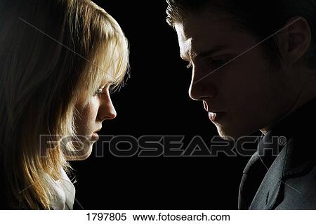 Side profile of a couple looking serious View Large Photo Image Stock Photography - Side profile of a couple looking serious. Fotosearch