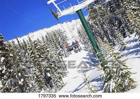 Stock Photography - Skiers on a chairlift . Fotosearch