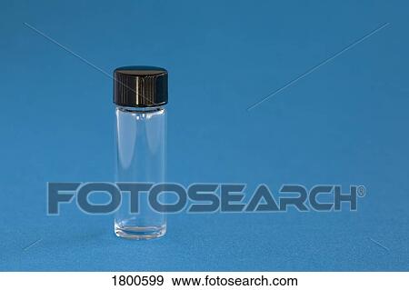 Stock Photo - Small glass vial on blue background . Fotosearch