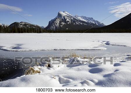 Stock Image - Snowy expanse by the mountains. Fotosearch