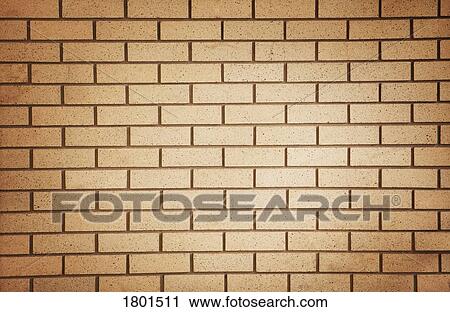 Stock Image - Spotlight on an orange brick wall. Fotosearch