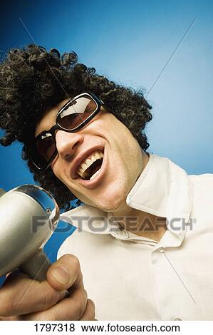 Stock Photo - Stepping up to the microphone. Fotosearch