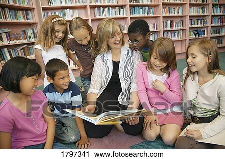Stock Image - Teacher reading to her students. Fotosearch