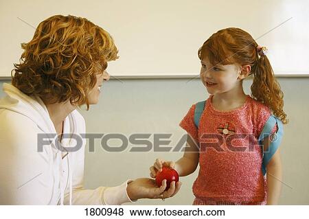 Stock Photo - Teacher with her student. Fotosearch