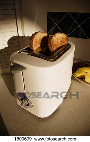 Toast in toaster View Large Photo Image Stock Photo - Toast in toaster. Fotosearch