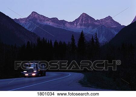 Picture - Transport truck traveling highway through mountains. Fotosearch