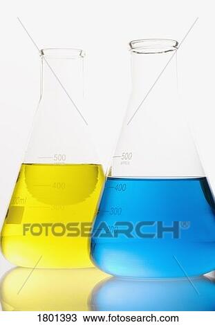 Stock Image - Two flasks with blue and yellow solutions. Fotosearch