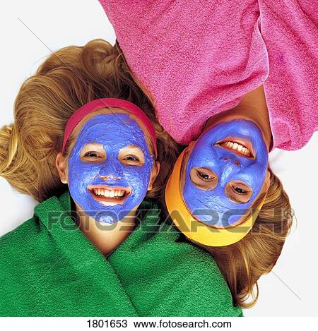 Stock Image - Two girls getting pampered. Fotosearch