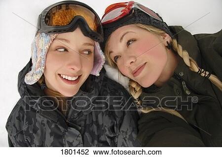 Stock Image - Two girls in winter wear with ski glasses. Fotosearch
