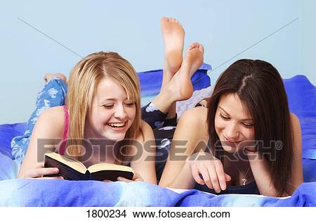 Two girls reading together View Large Photo Image Picture - Two girls reading together. Fotosearch
