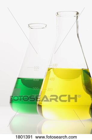 Stock Image - Two glass flasks with colored solutions. Fotosearch