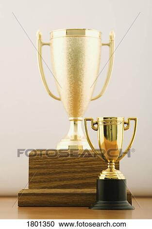 Two gold trophy cups View Large Photo Image Stock Image - Two gold trophy cups. Fotosearch