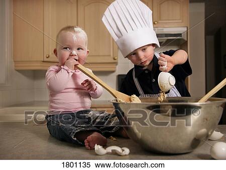Stock Photography - Two kids baking alone. Fotosearch