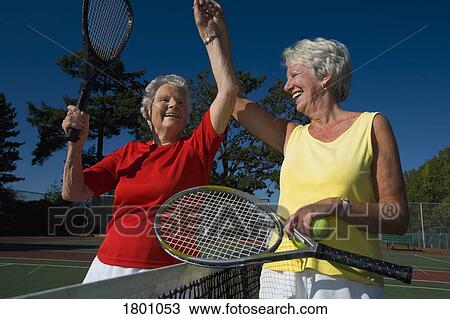 Two senior women playing tennis View Large Photo Image Stock Image - Two senior women playing tennis. Fotosearch