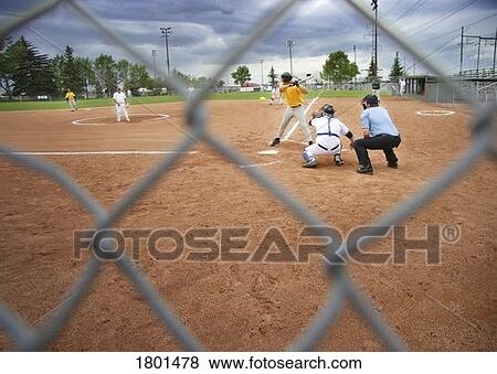 Stock Photo - Watching a baseball game through a chain link fence. Fotosearch