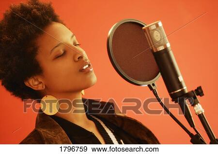 Stock Photo - Woman at microphone. Fotosearch