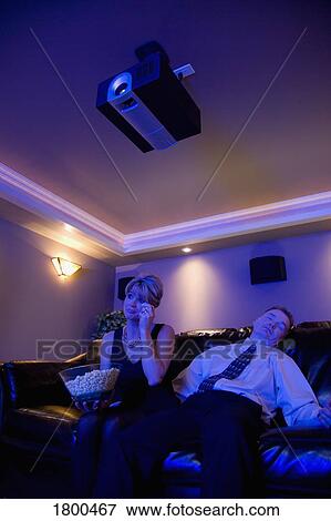 Woman crying at movie, man asleep View Large Photo Image Stock Photo - Woman crying at movie, man asleep. Fotosearch