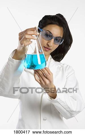 Stock Photo - Woman holding a beaker. Fotosearch