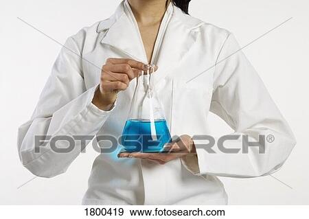 Stock Photo - Woman holding a beaker. Fotosearch