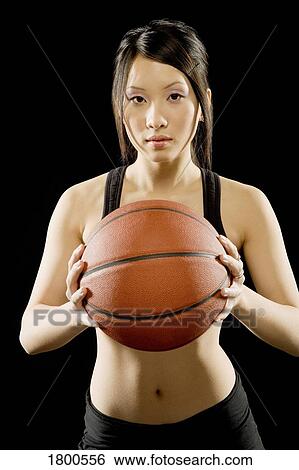 Woman holding basketball View Large Photo Image Stock Photograph - Woman holding basketball. Fotosearch
