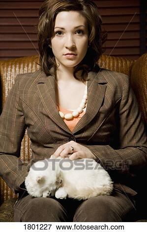 Stock Photo - Woman holding cat. Fotosearch
