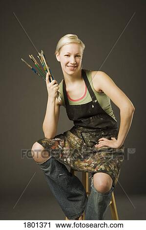 Woman holding paintbrushes View Large Photo Image Stock Image - Woman holding paintbrushes. Fotosearch