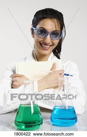 Woman in lab coat smiling View Large Photo Image Stock Image - Woman in lab coat smiling. Fotosearch