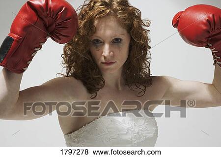Woman in wedding dress with boxing gloves View Large Photo Image Stock Photo - Woman in wedding dress with boxing gloves. Fotosearch