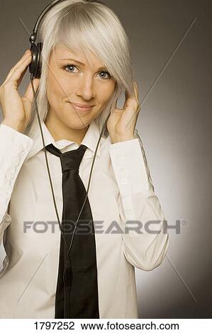 Stock Image - Woman listening to music. Fotosearch