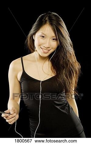 Stock Photo - Woman listening to music. Fotosearch