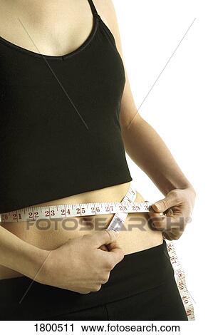 Woman measuring her waist View Large Photo Image Stock Image - Woman measuring her waist. Fotosearch