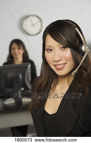 Stock Image - Woman On Headset. Fotosearch