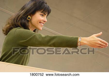 Stock Image - Woman reaching out her hand. Fotosearch