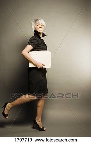 Stock Photo - Woman running with documents. Fotosearch