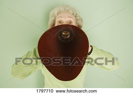 Stock Image - Woman shouting into a bullhorn. Fotosearch