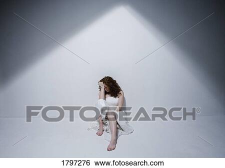 Woman sitting alone View Large Photo Image Stock Photograph - Woman sitting alone. Fotosearch