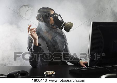 Stock Image - Woman smoking with a gas mask. Fotosearch
