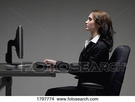 Picture - Woman using a computer. Fotosearch