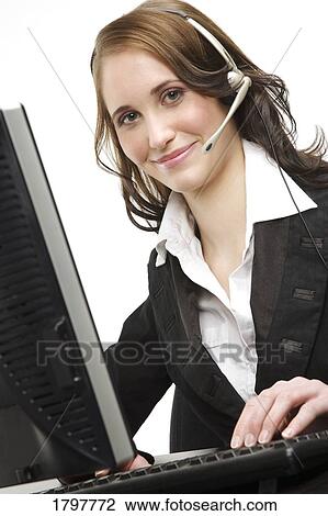 Woman wearing a headset and using a computer View Large Photo Image Stock Image - Woman wearing a headset and using a computer. Fotosearch