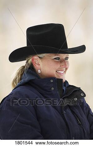 Woman with cowboy hat and warm coat View Large Photo Image Picture - Woman with cowboy hat and warm coat. Fotosearch