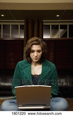 Stock Image - Woman working on laptop. Fotosearch