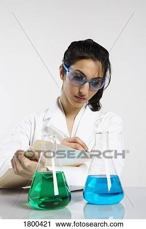 Woman writing results with beakers View Large Photo Image Stock Image - Woman writing results with beakers. Fotosearch
